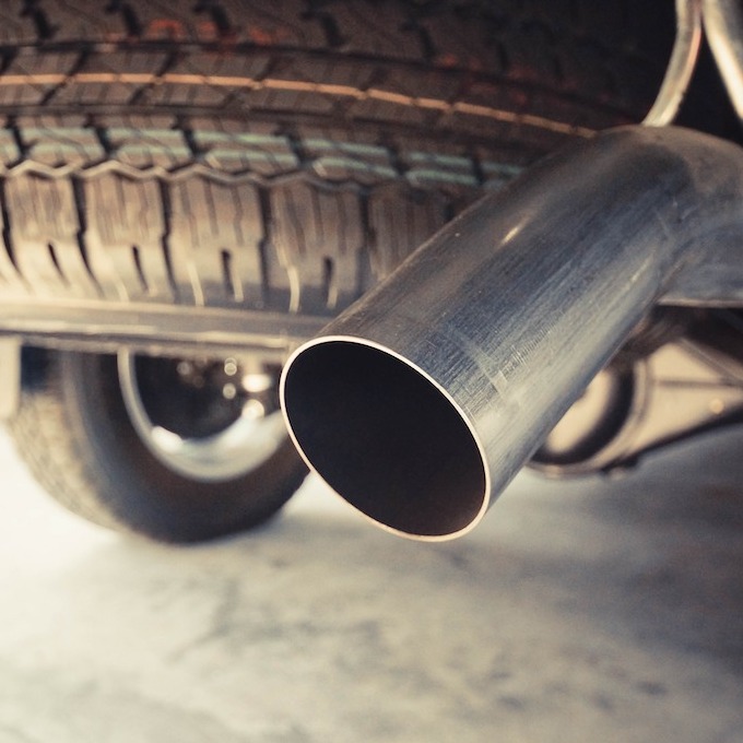 Catalytic converter attached to a car in a garage