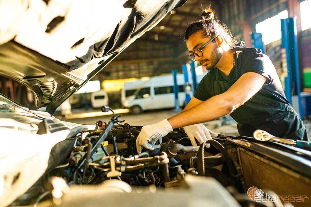 ASE certified mechanic working under the hood at J1 Auto Repair
