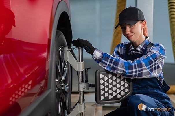 Mechanic performing a wheel alignment at J1 Auto Repair
