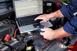 Hands of mechanic working in auto repair shop.